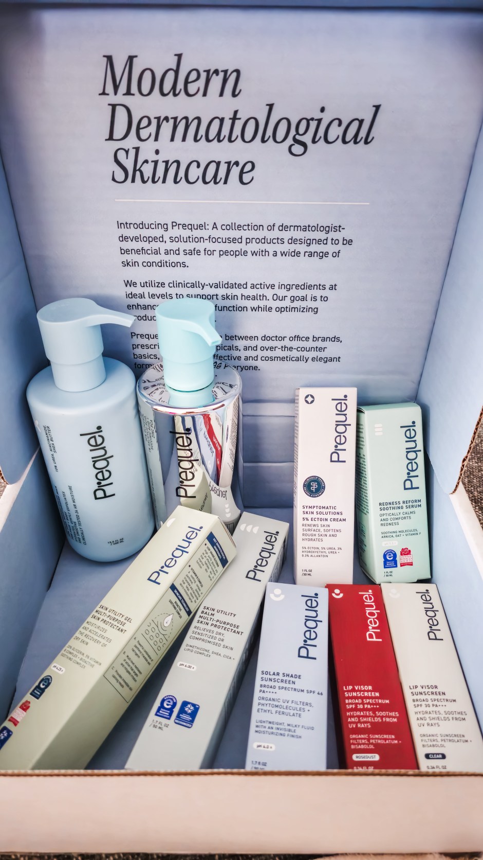 Prequel skincare routine products used to clear maskne, including cleanser, hypochlorous acid spray, serums, moisturizer, sunscreen, and scar care