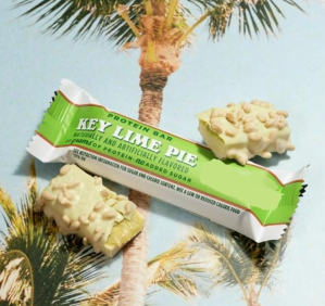 Key Lime Pie protein bar by Barebells on a tropical background, a healthy snack idea for GLP-1 maintenance.